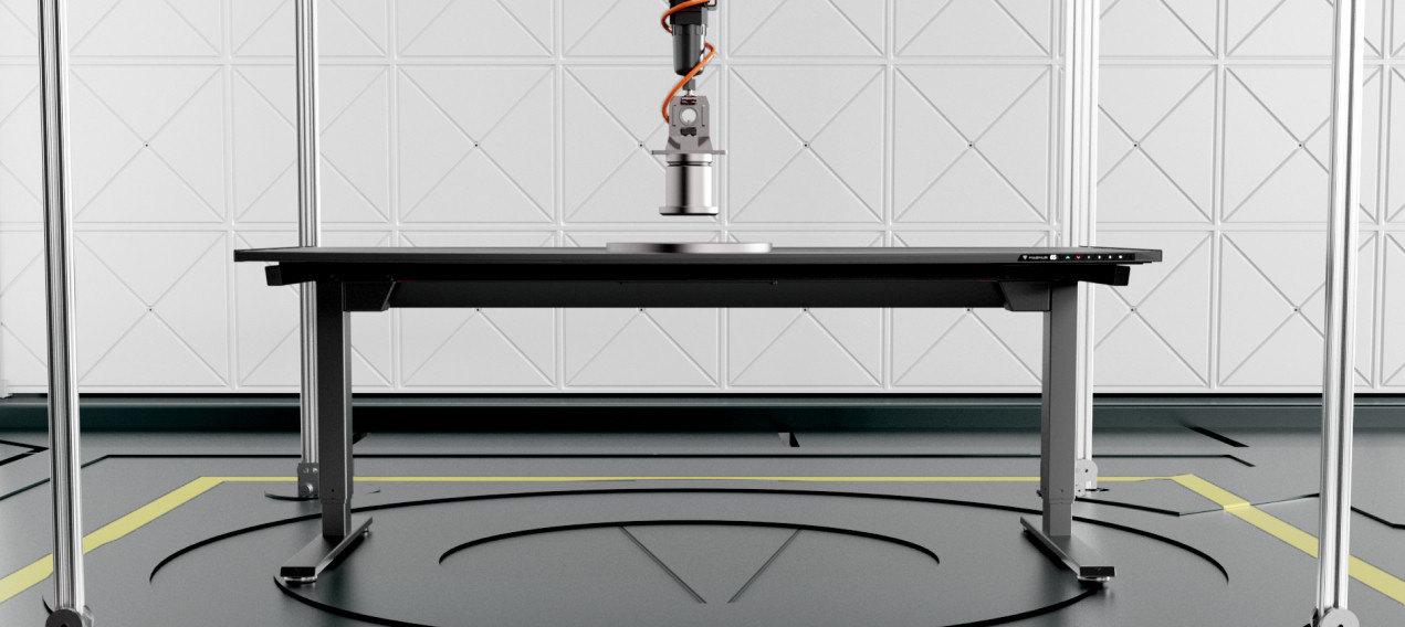 An R&D image of the Secretlab MAGNUS Pro standing desk undergoing load compression tests