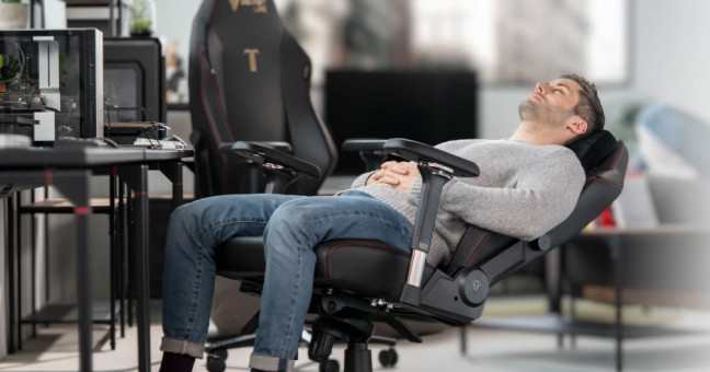 A person lying down, resting comfortably on a Secretlab TITAN Evo gaming chair