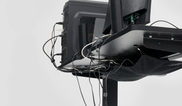 Cables routing to the back and under the table in a netting hammock on typical desks